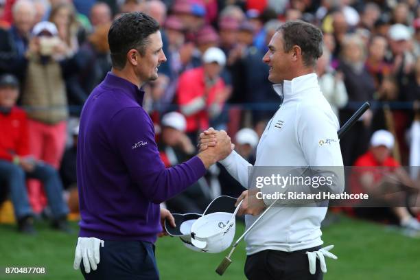 Justin Rose of England is congratulated by Nicolas Colsaerts of Belgium on the 18th green during the final round of the Turkish Airlines Open at the...