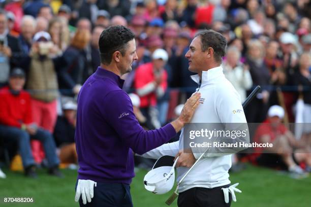 Justin Rose of England is congratulated by Nicolas Colsaerts of Belgium on the 18th green during the final round of the Turkish Airlines Open at the...