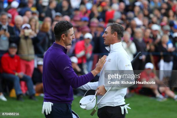Justin Rose of England is congratulated by Nicolas Colsaerts of Belgium on the 18th green during the final round of the Turkish Airlines Open at the...