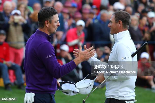 Justin Rose of England is congratulated by Nicolas Colsaerts of Belgium on the 18th green during the final round of the Turkish Airlines Open at the...