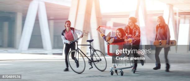 young adults running at abandoned construction site - b12 stock pictures, royalty-free photos & images