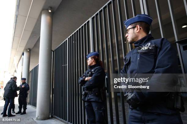 Belgian police officers stand guard at the public prosecutor's office in Brussels, Belgium, on Sunday, Nov. 5, 2017. Ousted Catalan...