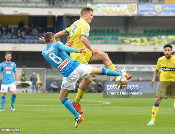 Valter Birsa of Chievo Verona competes with Jorginho of SSC Napoli during the Serie A match between AC Chievo Verona and SSC Napoli at Stadio...