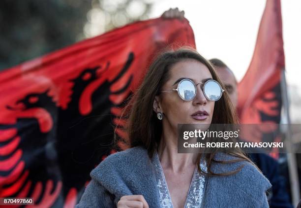 Woman in front of an Albanian flag takes part in a demonstration of Macedonian Albanians in Skopje on November 5 to protest against the verdict of...