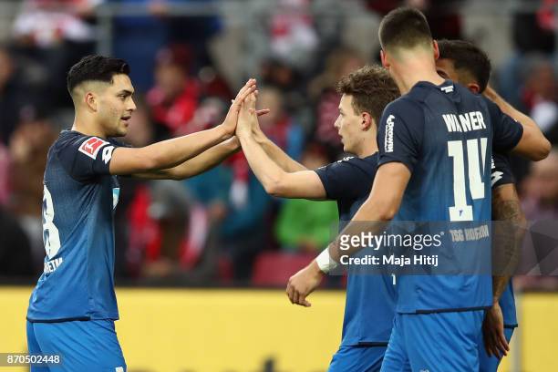 Dennis Geiger of Hoffenheim celebrates his team's first goal with team mates Nadiem Amiri and Sandro Wagner during the Bundesliga match between 1. FC...