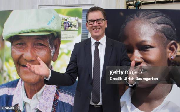 Climate Conference in Bonn. Dr. Gerd Mueller, Federal Minister for Economic, Cooperation and Development , between the portraits of two colored...