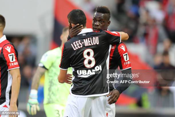 Nice's Italian forward Mario Balotelli celebrates with his teammate after scoring during the French L1 football match Nice vs Dijon on November 5,...