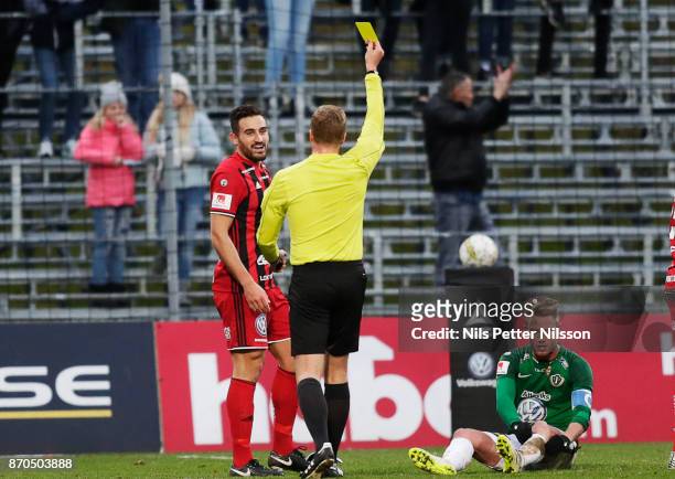 Sotirios Papagiannopoulus of Ostersunds FK is shown a yellow card by Glenn Nyberg, referee during the Allsvenskan match between Jonkopings Sodra IF...