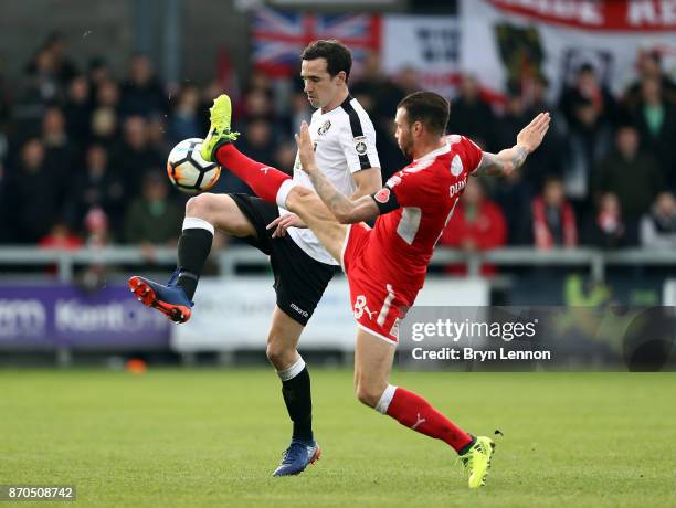 Danny Harris of Dartford is tackled by James Dunne of Swindon Town during The Emirates FA Cup first round match between Dartford and Swindon Town at...