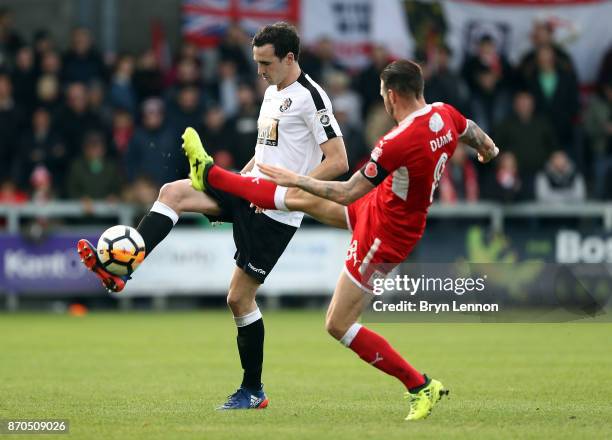 Danny Harris of Dartford is tackled by James Dunne of Swindon Town during The Emirates FA Cup first round match between Dartford and Swindon Town at...