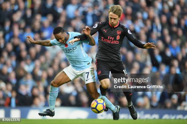 Nacho Monreal of Arsenal fouls Raheem Sterling of Manchester City and a penalty is awarded during the Premier League match between Manchester City...