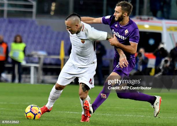Roma's midfielder from Belgium Radja Nainggolan fights for the ball with Fiorentina's Argentinian defender German Pezzella during the Italian Serie A...