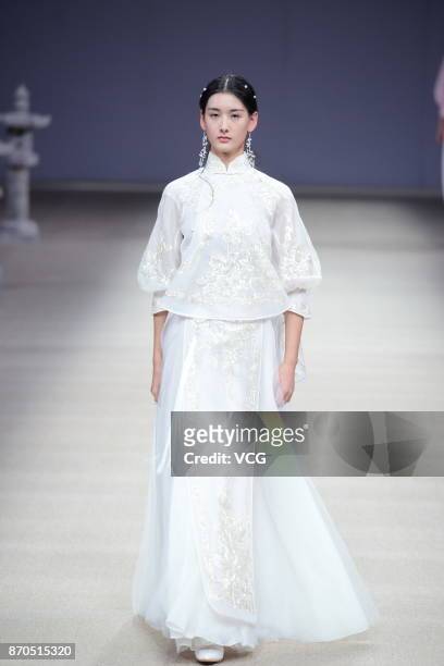 Model showcases designs on the runway at Heaven Gaia collection by designer Xiong Ying during the Mercedes-Benz China Fashion Week Spring/Summer 2018...