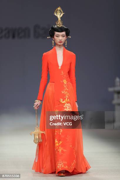 Model showcases designs on the runway at Heaven Gaia collection by designer Xiong Ying during the Mercedes-Benz China Fashion Week Spring/Summer 2018...