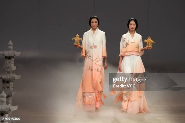 Models showcase designs on the runway at Heaven Gaia collection by designer Xiong Ying during the Mercedes-Benz China Fashion Week Spring/Summer 2018...