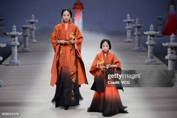 Models showcase designs on the runway at Heaven Gaia collection by designer Xiong Ying during the Mercedes-Benz China Fashion Week Spring/Summer 2018...