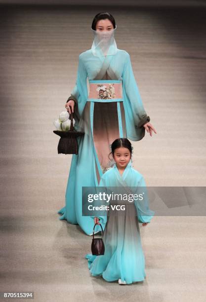 Models showcase designs on the runway at Heaven Gaia collection by designer Xiong Ying during the Mercedes-Benz China Fashion Week Spring/Summer 2018...