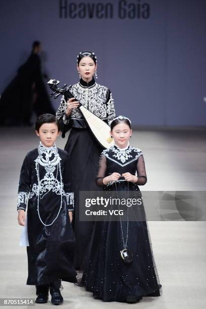 Models showcase designs on the runway at Heaven Gaia collection by designer Xiong Ying during the Mercedes-Benz China Fashion Week Spring/Summer 2018...