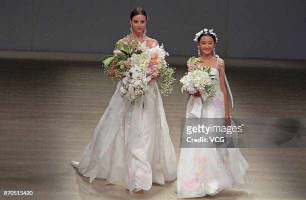 Models showcase designs on the runway at Heaven Gaia collection by designer Xiong Ying during the Mercedes-Benz China Fashion Week Spring/Summer 2018...