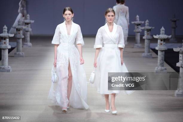 Models showcase designs on the runway at Heaven Gaia collection by designer Xiong Ying during the Mercedes-Benz China Fashion Week Spring/Summer 2018...