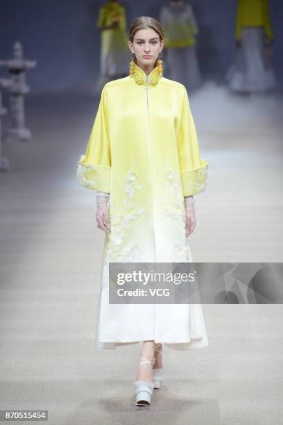 Model showcases designs on the runway at Heaven Gaia collection by designer Xiong Ying during the Mercedes-Benz China Fashion Week Spring/Summer 2018...