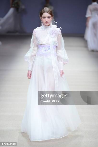 Model showcases designs on the runway at Heaven Gaia collection by designer Xiong Ying during the Mercedes-Benz China Fashion Week Spring/Summer 2018...