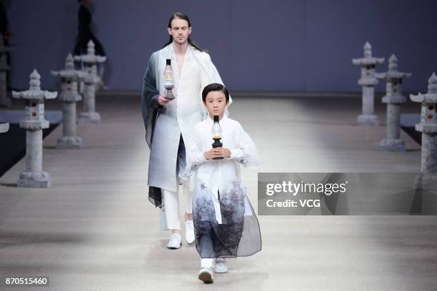 Models showcase designs on the runway at Heaven Gaia collection by designer Xiong Ying during the Mercedes-Benz China Fashion Week Spring/Summer 2018...