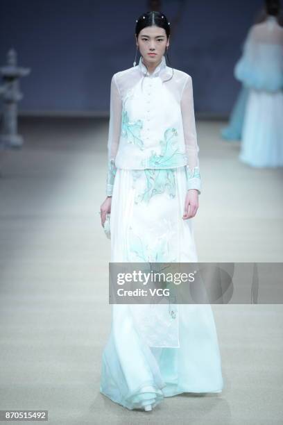 Model showcases designs on the runway at Heaven Gaia collection by designer Xiong Ying during the Mercedes-Benz China Fashion Week Spring/Summer 2018...