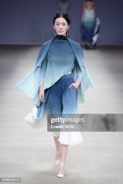 Model showcases designs on the runway at Heaven Gaia collection by designer Xiong Ying during the Mercedes-Benz China Fashion Week Spring/Summer 2018...