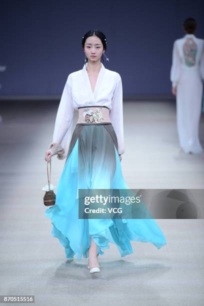 Model showcases designs on the runway at Heaven Gaia collection by designer Xiong Ying during the Mercedes-Benz China Fashion Week Spring/Summer 2018...