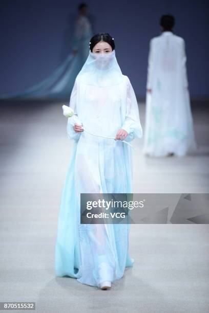 Model showcases designs on the runway at Heaven Gaia collection by designer Xiong Ying during the Mercedes-Benz China Fashion Week Spring/Summer 2018...