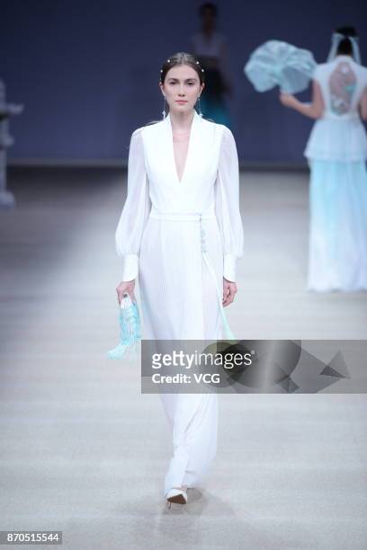 Model showcases designs on the runway at Heaven Gaia collection by designer Xiong Ying during the Mercedes-Benz China Fashion Week Spring/Summer 2018...