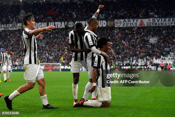 Juventus' Colombian forward Juan Cuadrado celebrates with teammates after scoring during the Italian Serie A football match Juventus vs Benevento at...
