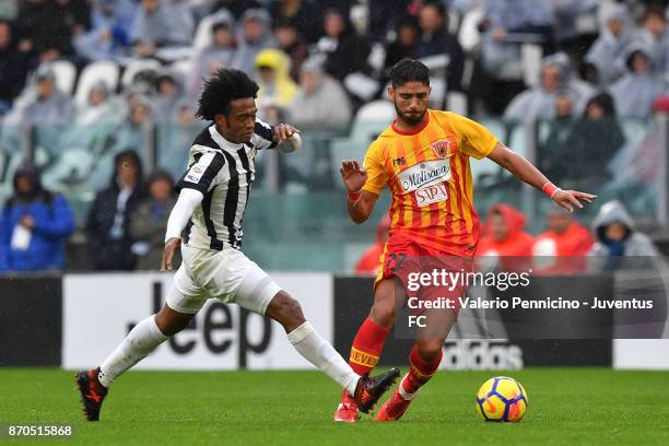 Juan Cuadrado of Juventus and Achraf Lazaar of Benevento compete for the ball during the Serie A match between Juventus and Benevento Calcio on...