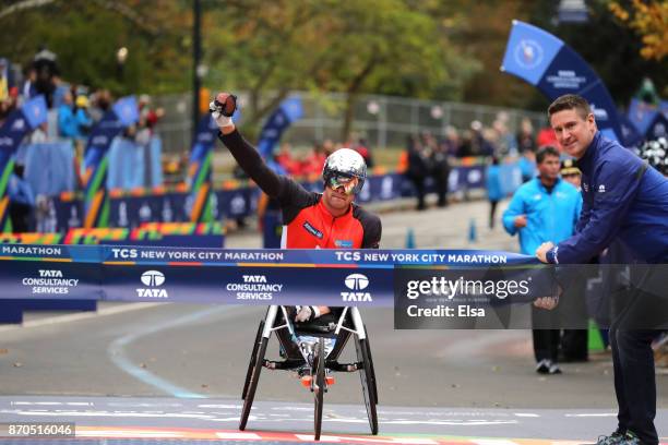 Marcel Hug of Switzerland celebrates winning the Professional Men's Wheelchair Division of the 2017 TCS New York City Marathon in Central Park on...