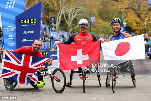 Marcel Hug of Switzerland celebrates winning the Professional Men's Wheelchair Division with John Charles Smith of the United Kingdom and Sho...