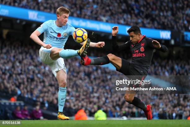 Kevin de Bruyne of Manchester City is challenged by Alexis Sanchez of Arsenal during the Premier League match between Manchester City and Arsenal at...