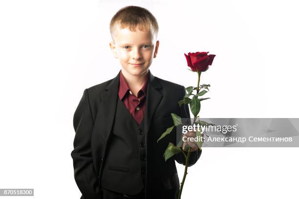 guy with the red rose. young man distinguished figure in a dark suit. - birthday suit ストックフォトと画像