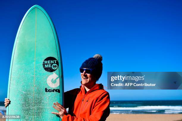 Paddy Cosgrave, Irish entrepreneur and co-founder of Web Summit, poses with a surfboard at Foz do Lizandro beach in Ericeira on November 5, 2017...