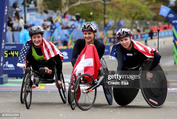 Manuela Schar of Switzerland celebrates winning the Professional Women's Wheelchair Division with Tatyana McFadden of the United States and Amanda...