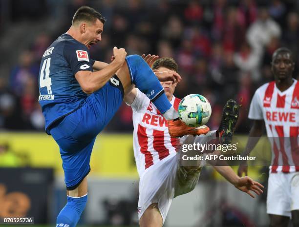 Hoffenheim's German forward Sandro Wagner and Cologne's German defender Dominique Heintz vie for the ball during the German first division Bundesliga...