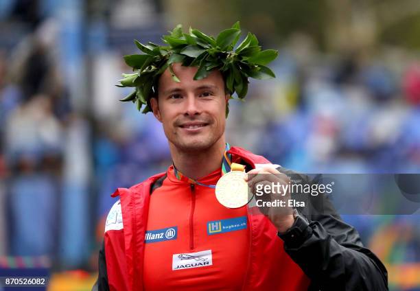 Marcel Hug of Switzerland celebrates winning the Professional Men's Wheelchair Division of the 2017 TCS New York City Marathon in Central Park on...