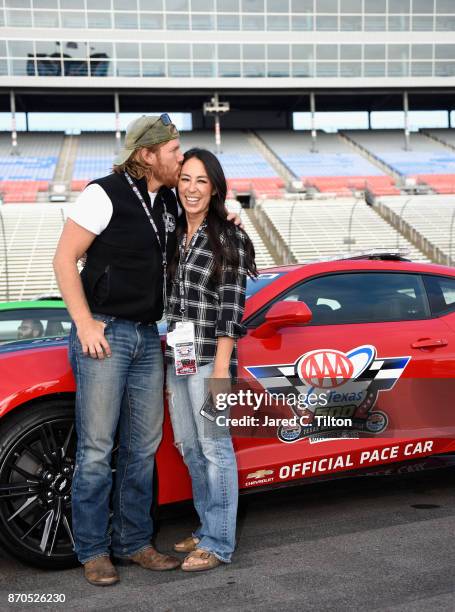 Fixer Upper' stars Chip and Joanna Gaines pose with the Monster Energy NASCAR Cup Series AAA Texas 500 pace car at Texas Motor Speedway on November...