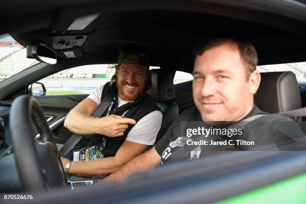 Fixer Upper' star Chip Gaines sits with Ryan Newman, driver of the Grainger Chevrolet, in the Monster Energy NASCAR Cup Series AAA Texas 500 pace car...