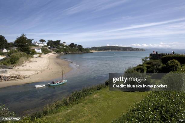 a small boat heading out to sea from the abersoch marina. - abersoch stock pictures, royalty-free photos & images