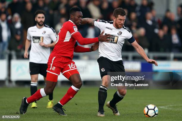 Elliot Bradbrook of Dartford is tackled by Amine Linganzi of Swindon Town during The Emirates FA Cup first round match between Dartford and Swindon...