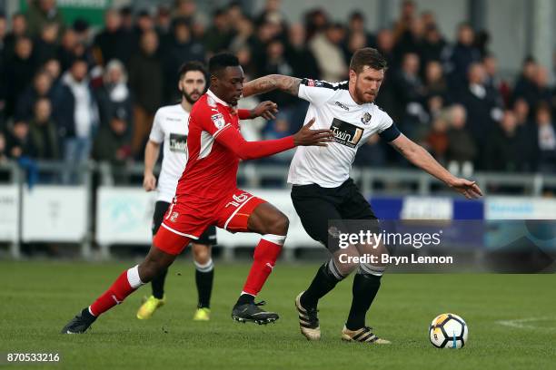 Elliot Bradbrook of Dartford is tackled by Amine Linganzi of Swindon Town during The Emirates FA Cup first round match between Dartford and Swindon...