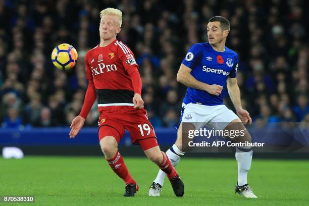 Watford's English midfielder Will Hughes vies with Everton's English defender Leighton Baines during the English Premier League football match...