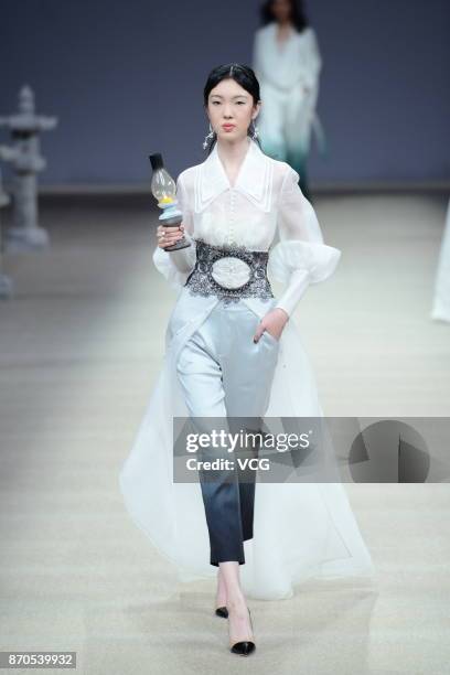 Model showcases designs on the runway at Heaven Gaia collection by designer Xiong Ying during the Mercedes-Benz China Fashion Week Spring/Summer 2018...