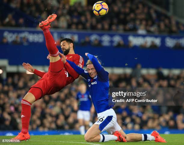 Watford's Uruguayan defender Miguel Britos vies with Everton's English midfielder Tom Davies during the English Premier League football match between...